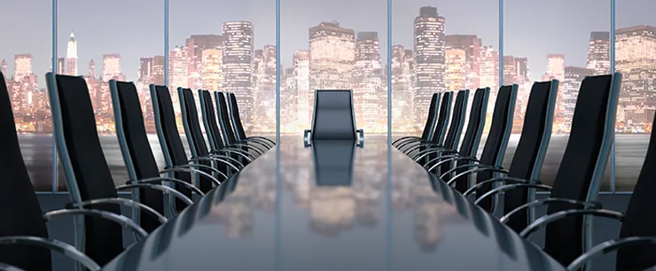 Empty boardroom overlooking a city skyline